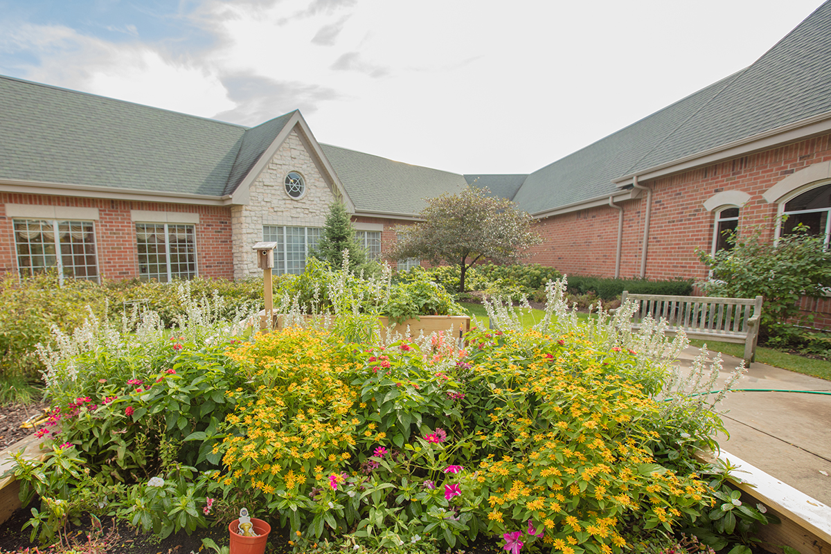 view of the beautiful landscaping and courtyard setting at Newcastle Place Senior Living Community in Mequon, WI